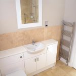 stone bathroom cupboard sink and towel rack