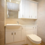beige bathroom cupboard sink and bathroom