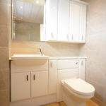 beige bathroom cupboard sink and toilet